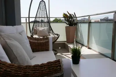 a porch with a hammock on a balcony at Charmful new flat with Hill view in Plovdiv