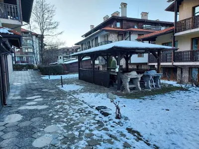 a pavilion with snow on the ground next to a building at 4 Seasons 2 - Top Lodge in Bansko