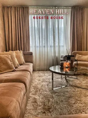 a living room with a couch and a glass table at Luxury guests house “Heaven Hill”, Pravets city in Pravets