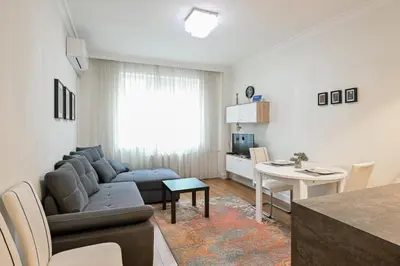 a living room with a couch and a table at St. Ivan Rilski flat in Sofia