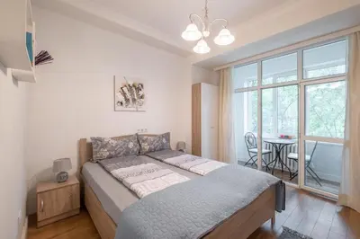 a bedroom with a bed and a large window at St. Ivan Rilski flat in Sofia