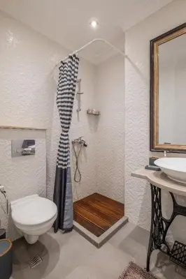 a bathroom with a shower and a toilet and a sink at St. Ivan Rilski flat in Sofia