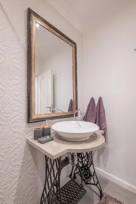 a bathroom with a sink and a mirror on a wall at St. Ivan Rilski flat in Sofia
