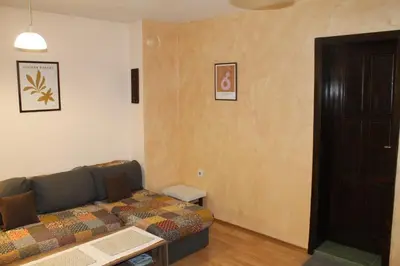 a living room with a couch and a door at Quiet central studio in Pazardzhik
