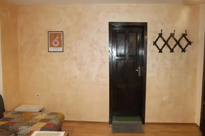 a room with a door and a room with a bed at Quiet central studio in Pazardzhik