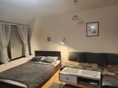 a living room with a bed and a couch at Quiet central studio in Pazardzhik