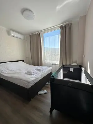 a small bedroom with a bed and a window at Rose apt South Park - Free Public Parking, Mountain View, self check-in, near metro, stores, family-friendly in Sofia
