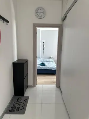 a hallway with a door leading to a bedroom with a bed at Rose apt South Park - Free Public Parking, Mountain View, self check-in, near metro, stores, family-friendly in Sofia