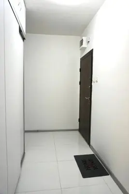a white room with a door and a black door mat at Rose apt South Park - Free Public Parking, Mountain View, self check-in, near metro, stores, family-friendly in Sofia