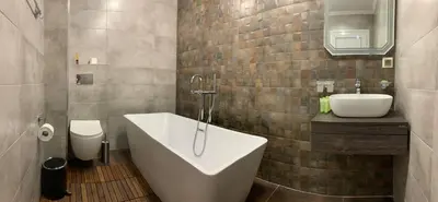 a bathroom with a tub and a sink and a toilet at Olive Apartment with terrace B100 in Grand Resort Pamporovo in Pamporovo