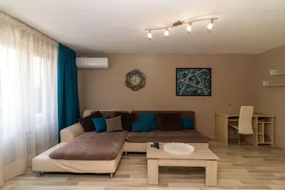 a living room with a couch and a table at Niko's 2 Bedroom Central Apartment in Sofia