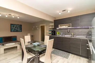 a kitchen with a glass table and chairs in a room at Niko's 2 Bedroom Central Apartment in Sofia