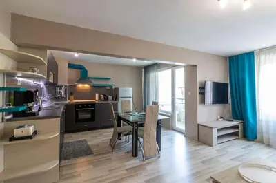 a kitchen and dining room with a table in a room at Niko's 2 Bedroom Central Apartment in Sofia