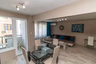 a living room with a table and a couch at Niko's 2 Bedroom Central Apartment in Sofia