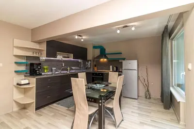 a kitchen with a table and chairs in a room at Niko's 2 Bedroom Central Apartment in Sofia