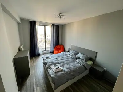 a bedroom with a bed and a window at Habitat 29 Apartment in Sofia