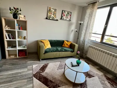 a living room with a couch and a table at Habitat 29 Apartment in Sofia