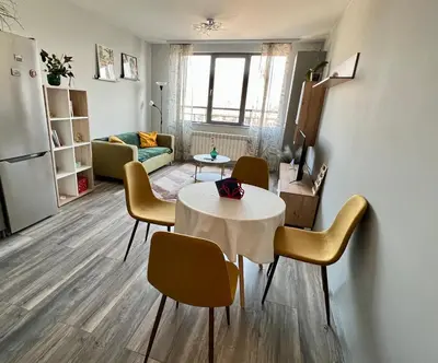 a kitchen and living room with a table and chairs at Habitat 29 Apartment in Sofia