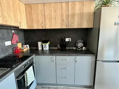 a kitchen with white cabinets and a stainless steel refrigerator at Habitat 29 Apartment in Sofia