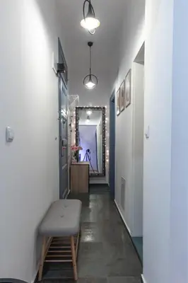 a hallway with a bench and a mirror at Vintage bohemian Paradise with Xbox Series X for BIG groups in Sofia