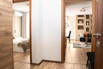 a room with a bed and a door leading to a bedroom at Gondola Apartments Lux in Bansko