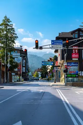 an empty street with a traffic light in a town at Gondola Apartments Lux in Bansko