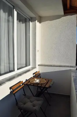 a table and two chairs in a room with windows at Orpheus and Eurydice in Smolyan