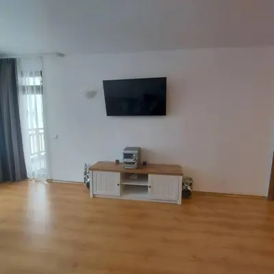 a living room with a tv on a white wall at Семи гарден in Borovets