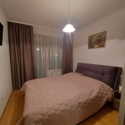 a bedroom with a large bed and a window at Семи гарден in Borovets