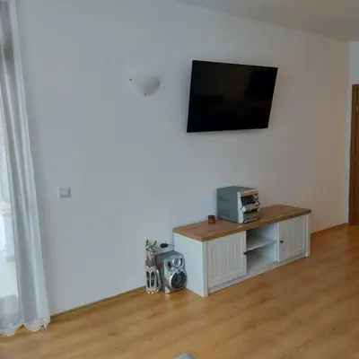 a living room with a flat screen tv on a wall at Семи гарден in Borovets