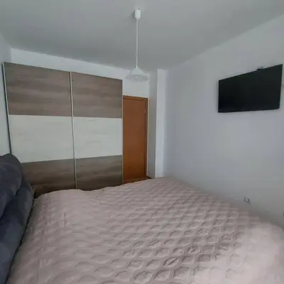a bedroom with a bed and a television in it at Семи гарден in Borovets