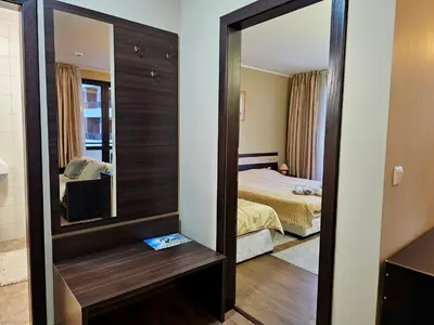 a mirror in a hotel room with a bedroom at Apartment at Dream Bansko in Bansko