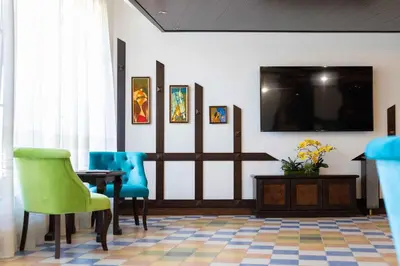 a waiting room with a table and chairs and a flat screen tv at Armaco Residence in Koprivshtitsa