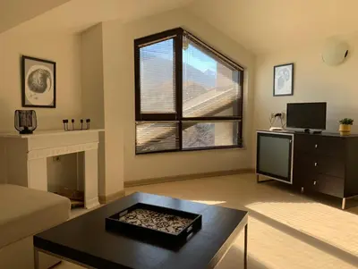 a living room with a couch and a table at Central Art Apartment in Bansko with Mountain View in Bansko