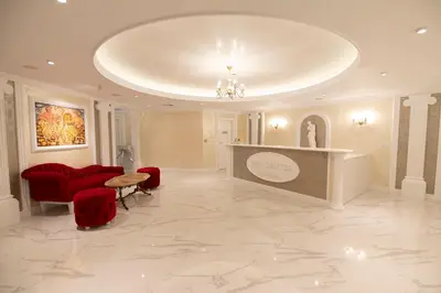 a large lobby with red chairs and a large ceiling at Glamping Alliance Hotel in Plovdiv