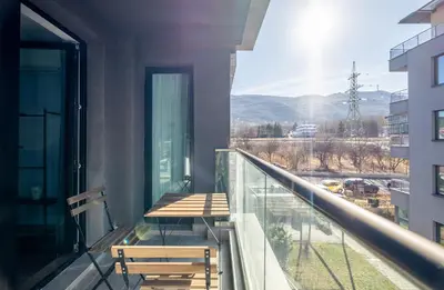 a balcony with a bench and a view of a city at Emirates Luxury Apartment Free Parking Terrace in Sofia