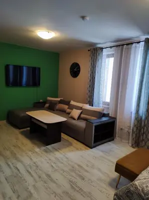 a living room with a couch and a table at Апартаменты Grand Ressort in Pamporovo