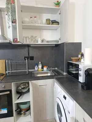 a kitchen with a sink and a washing machine at Diamond Heights apartament in Bansko