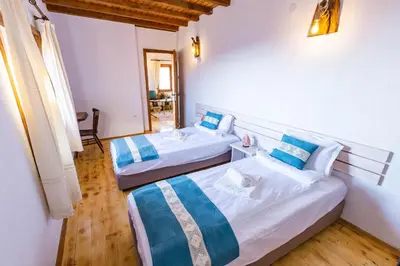 a room with two beds in a room at Комплекс Конна база Асгард in Golem Tsalim