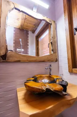 a bathroom with a large wooden sink with a mirror at Комплекс Конна база Асгард in Golem Tsalim