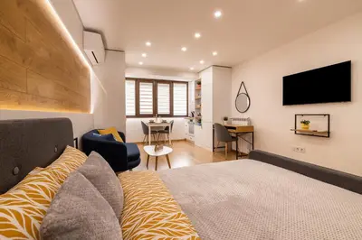 a bedroom with a bed and a desk and a television at Luxury Studio Living High-End Amenities and Great Location by Flat Mаnager in Sofia