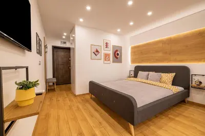 a bedroom with a bed and a flat screen tv at Luxury Studio Living High-End Amenities and Great Location by Flat Mаnager in Sofia