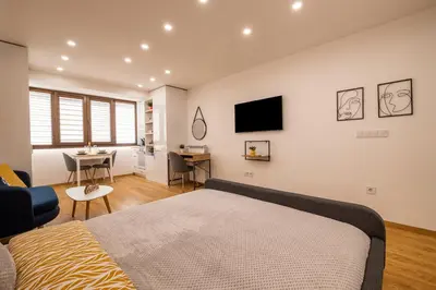 a bedroom with a bed and a desk and a tv at Luxury Studio Living High-End Amenities and Great Location by Flat Mаnager in Sofia