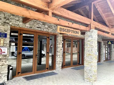 a facade of a building with glass doors at Peaceful Condo w/ Amazing View in Bansko