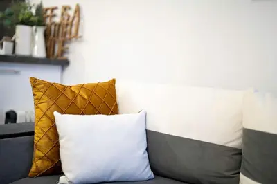 a couch with two pillows on top of it at Peaceful Condo w/ Amazing View in Bansko