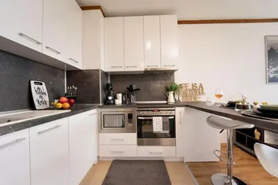a kitchen with white cabinets and stainless steel appliances at Peaceful Condo w/ Amazing View in Bansko