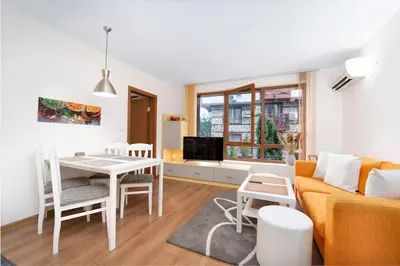 a living room with a couch and a table at Snow Legend Apartment with terrace in Bansko