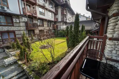 a balcony of a building with a yard at Snow Legend Apartment with terrace in Bansko
