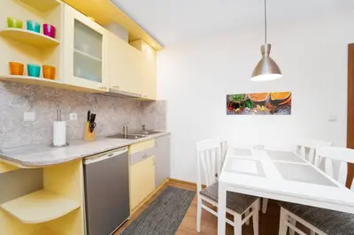a kitchen and dining room with a table and chairs at Snow Legend Apartment with terrace in Bansko