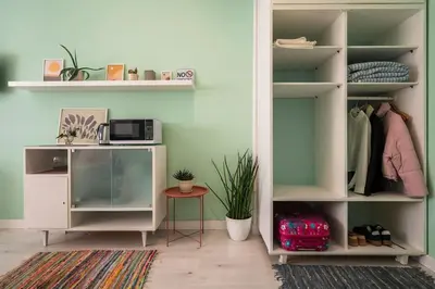 a room with a desk and a book shelf at Студио Римски Стадион in Plovdiv